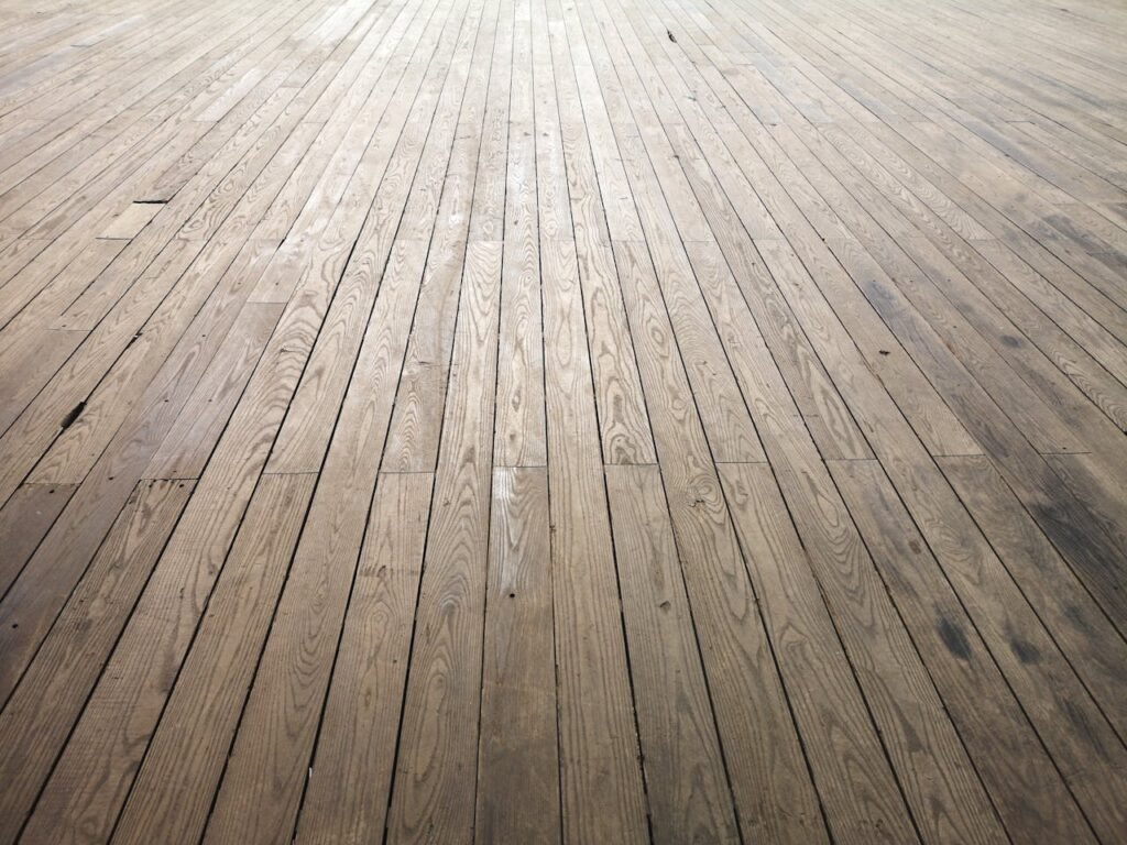 A wide angle view of aged wooden floor planks showing natural texture and grain pattern.