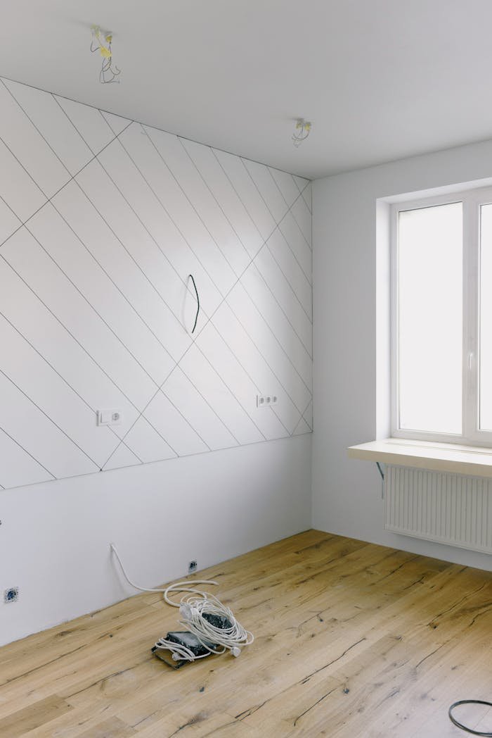 Electrical and installation work in light empty room with big window and new design